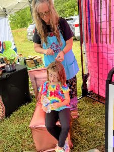 putting tinsel into hair as the glitter queen